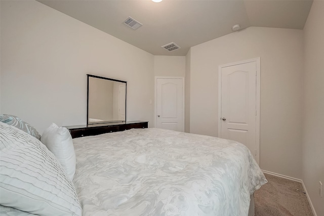 carpeted bedroom featuring a closet and vaulted ceiling