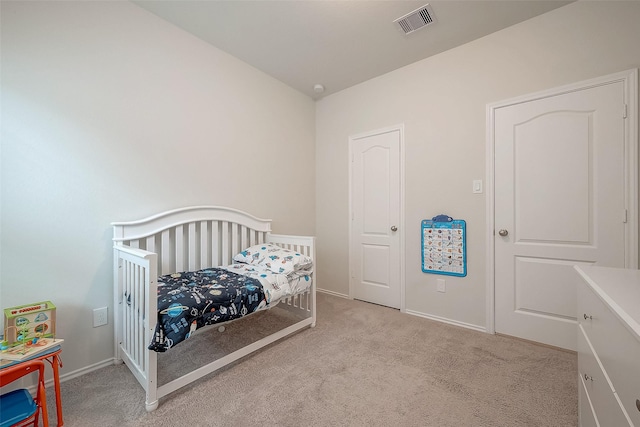 carpeted bedroom with a crib