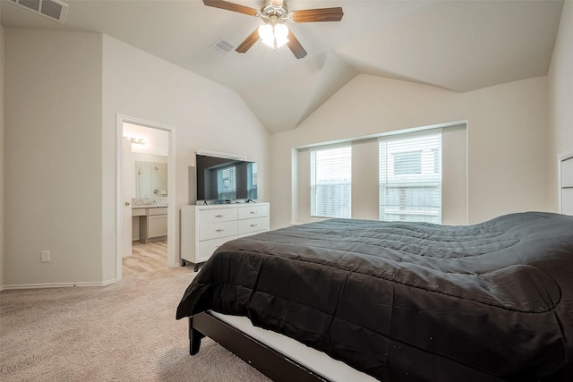 carpeted bedroom with connected bathroom, vaulted ceiling, and ceiling fan