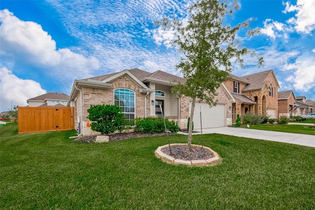 view of front of property with a front yard and a garage