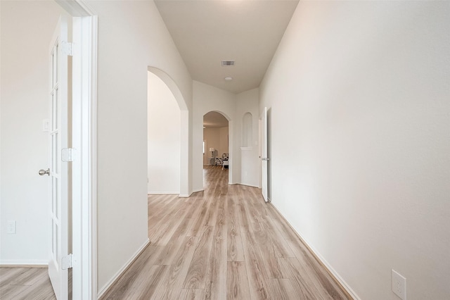 hall with light wood-type flooring