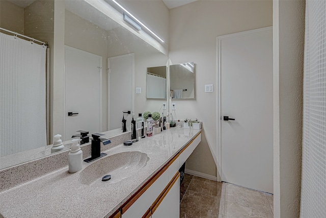 bathroom featuring tile patterned flooring and vanity