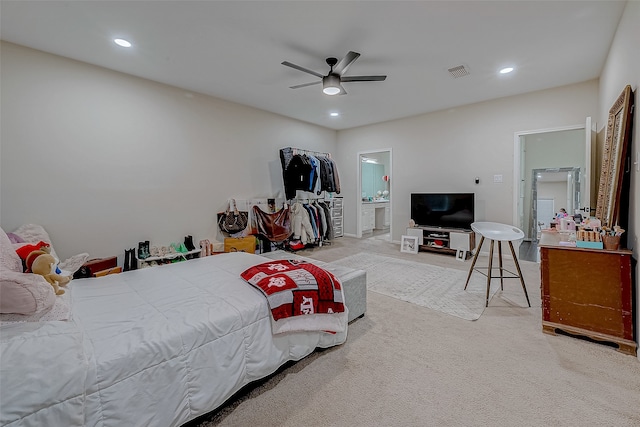 bedroom featuring ensuite bath, ceiling fan, and carpet