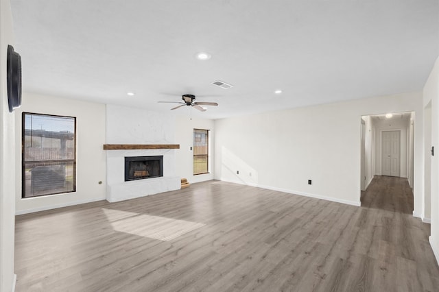 unfurnished living room with ceiling fan and light hardwood / wood-style flooring