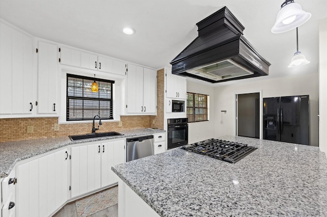 kitchen featuring decorative backsplash, sink, black appliances, white cabinetry, and hanging light fixtures