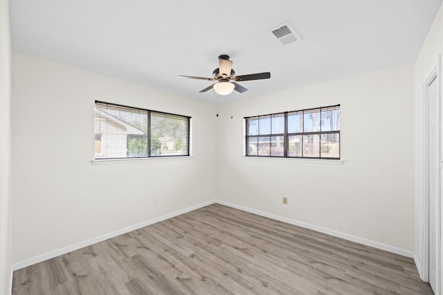 spare room featuring light hardwood / wood-style flooring and ceiling fan