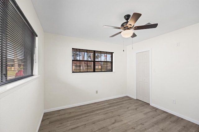 empty room featuring light hardwood / wood-style flooring and ceiling fan