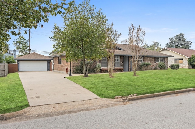 single story home featuring a garage, an outbuilding, and a front lawn