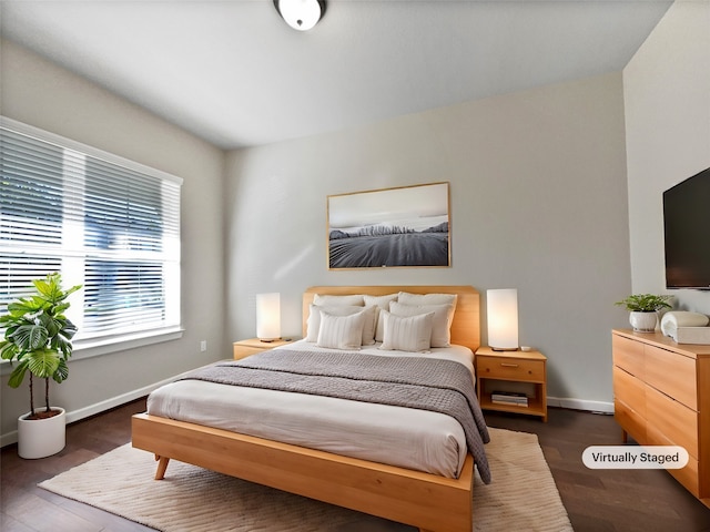 bedroom with dark hardwood / wood-style flooring