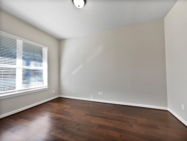 spare room with dark wood-type flooring