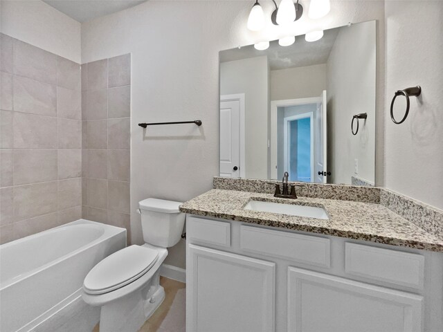 full bathroom featuring vanity, toilet, and tiled shower / bath