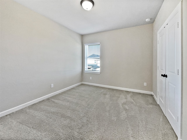 unfurnished bedroom with light colored carpet