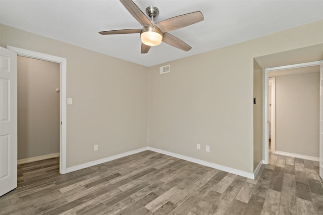 empty room with ceiling fan and wood-type flooring