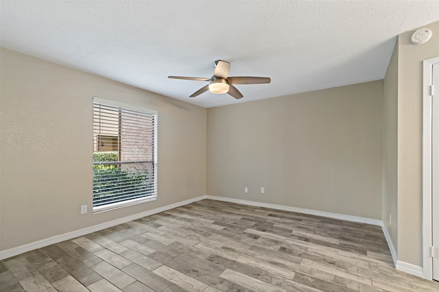 unfurnished room with ceiling fan, a textured ceiling, and light hardwood / wood-style flooring