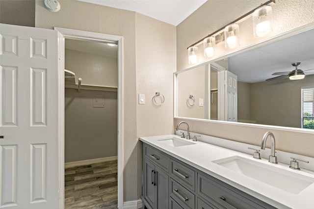 bathroom featuring ceiling fan, hardwood / wood-style floors, and vanity