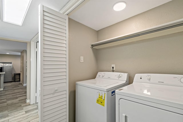 9000 Bissonnet St Unit 501, Houston, TX 77074 - laundry area featuring washing machine and dryer and light wood-style floors