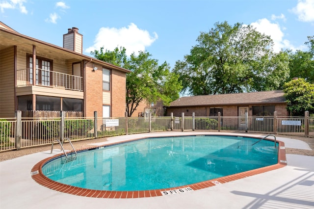 view of swimming pool featuring a patio area