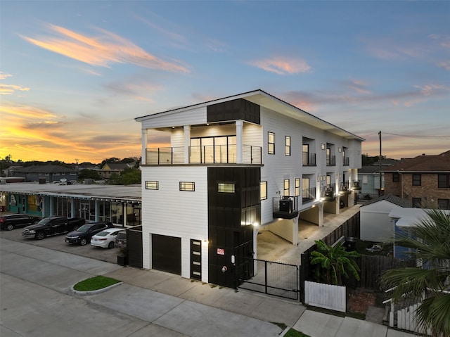 view of front of property with a balcony and a garage