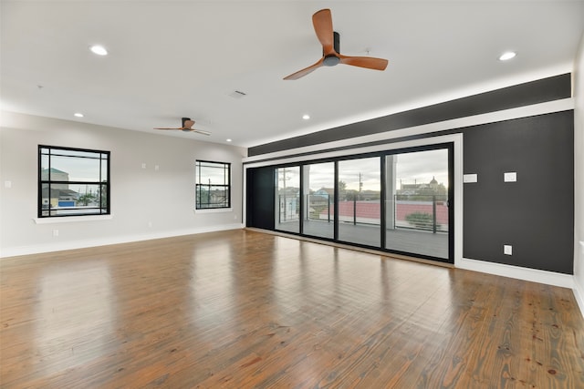 spare room with wood-type flooring and ceiling fan