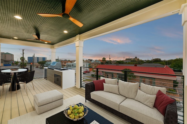 deck at dusk featuring grilling area