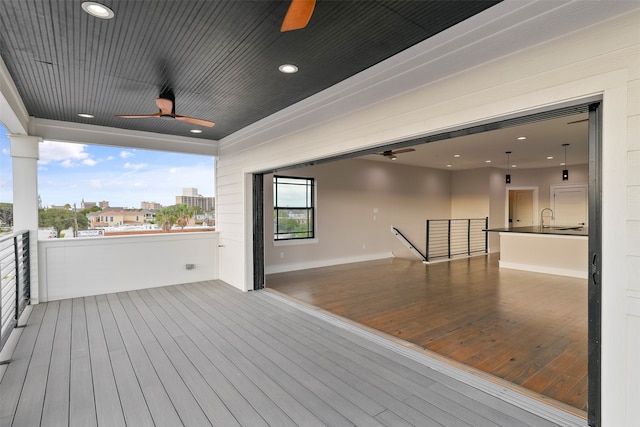 wooden deck featuring ceiling fan and sink