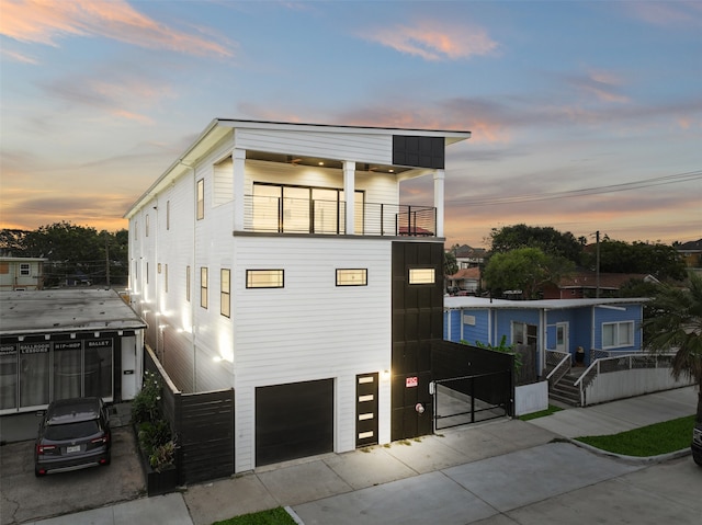 modern home featuring a balcony and a garage