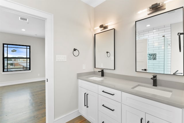 bathroom featuring vanity, wood-type flooring, and an enclosed shower