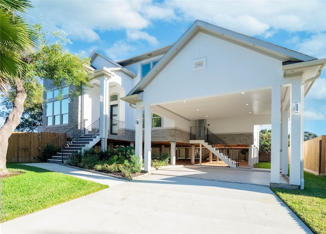 view of front of property with a front lawn and a carport