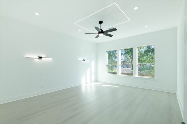 empty room featuring ceiling fan and light hardwood / wood-style floors