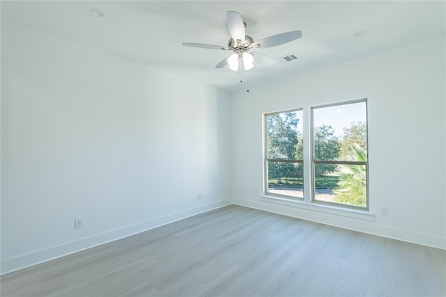 empty room with ceiling fan and light wood-type flooring