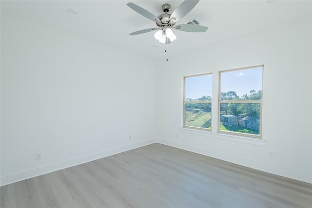 empty room featuring ceiling fan and light hardwood / wood-style flooring