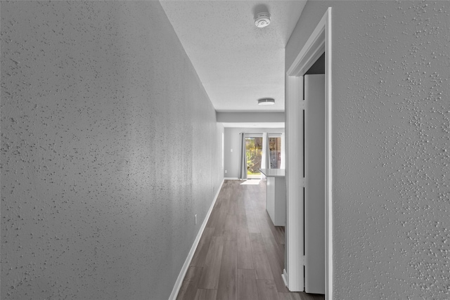 12900 Walden Rd Unit 419D, Montgomery, TX 77356 - corridor featuring baseboards and wood finished floors