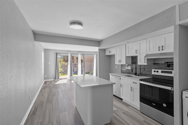 kitchen featuring white cabinetry, dishwasher, sink, stainless steel range with electric stovetop, and light wood-type flooring