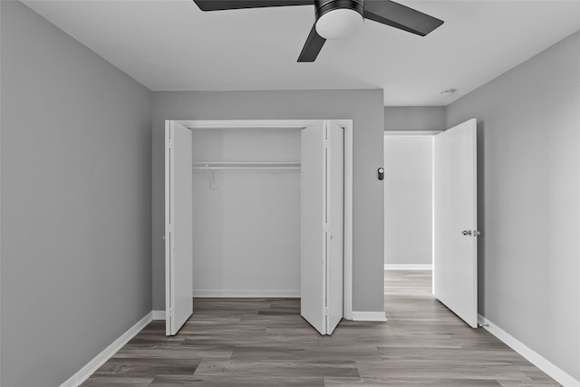 unfurnished bedroom with light wood-type flooring, a closet, and ceiling fan