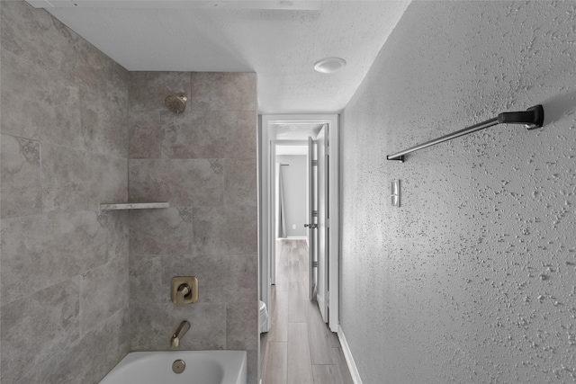 12900 Walden Rd Unit 419D, Montgomery, TX 77356 - full bath with washtub / shower combination and a textured ceiling