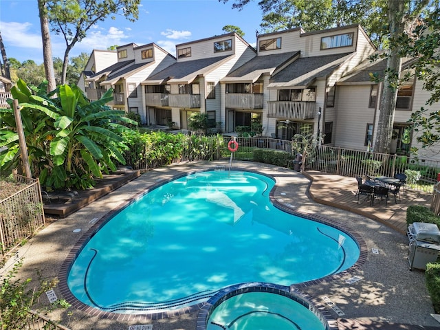 12900 Walden Rd Unit 419D, Montgomery, TX 77356 - view of swimming pool featuring a residential view and a pool with connected hot tub