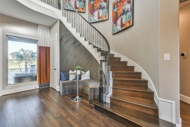 stairway with hardwood / wood-style floors