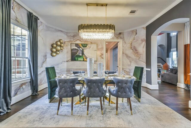 dining area featuring a chandelier, dark hardwood / wood-style floors, and ornamental molding