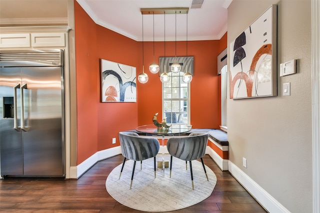 dining space featuring dark hardwood / wood-style floors and ornamental molding