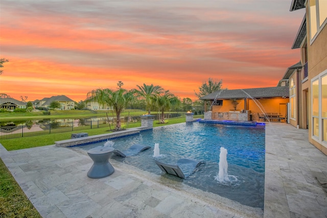 pool at dusk with pool water feature, a yard, and a patio