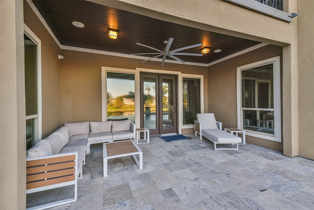 patio terrace at dusk with an outdoor living space, a balcony, and ceiling fan