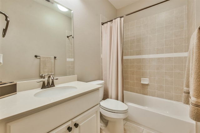 full bathroom featuring tile patterned floors, shower / bath combo with shower curtain, vanity, and toilet