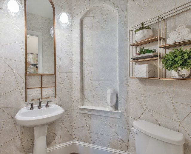 bathroom with tile walls and toilet