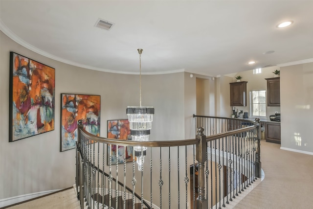 corridor featuring light colored carpet, an inviting chandelier, and ornamental molding