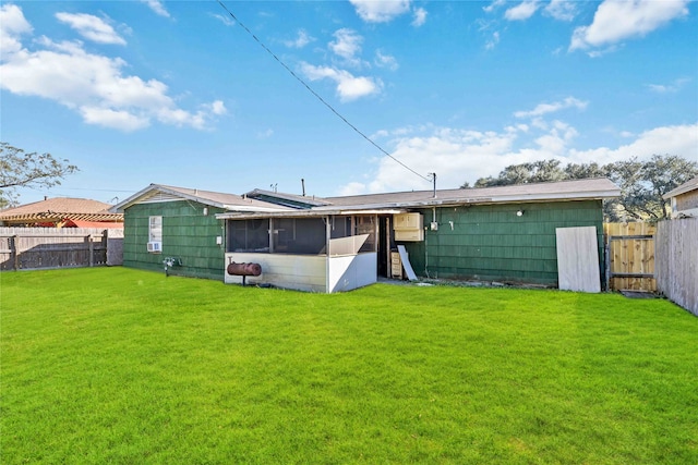 back of property with a lawn