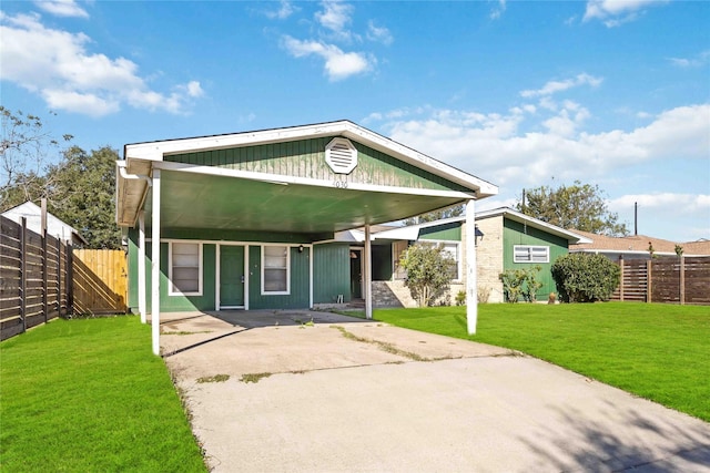 bungalow-style house featuring a carport and a front yard