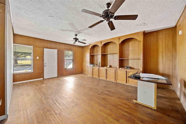 unfurnished living room featuring dark hardwood / wood-style floors and a textured ceiling