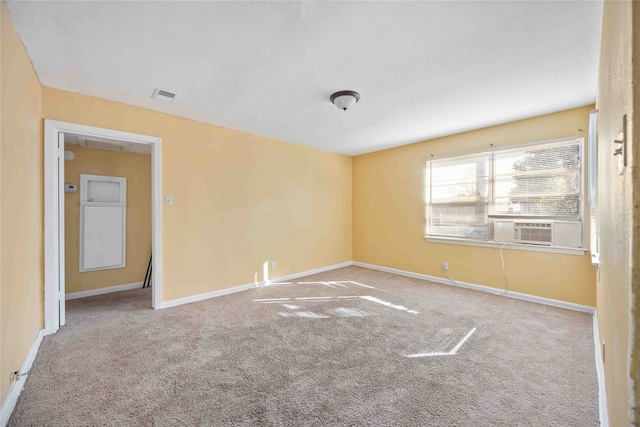 empty room featuring cooling unit and carpet floors