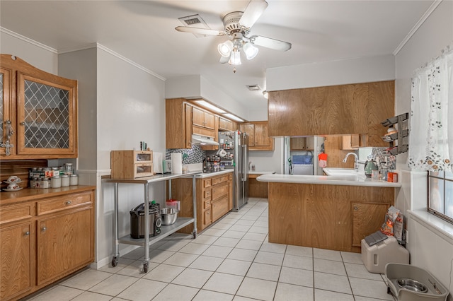 kitchen with kitchen peninsula, stainless steel fridge, ceiling fan, crown molding, and sink