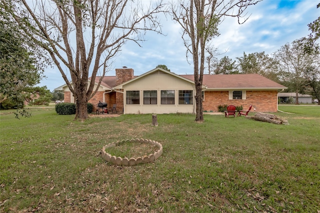 rear view of house with a yard